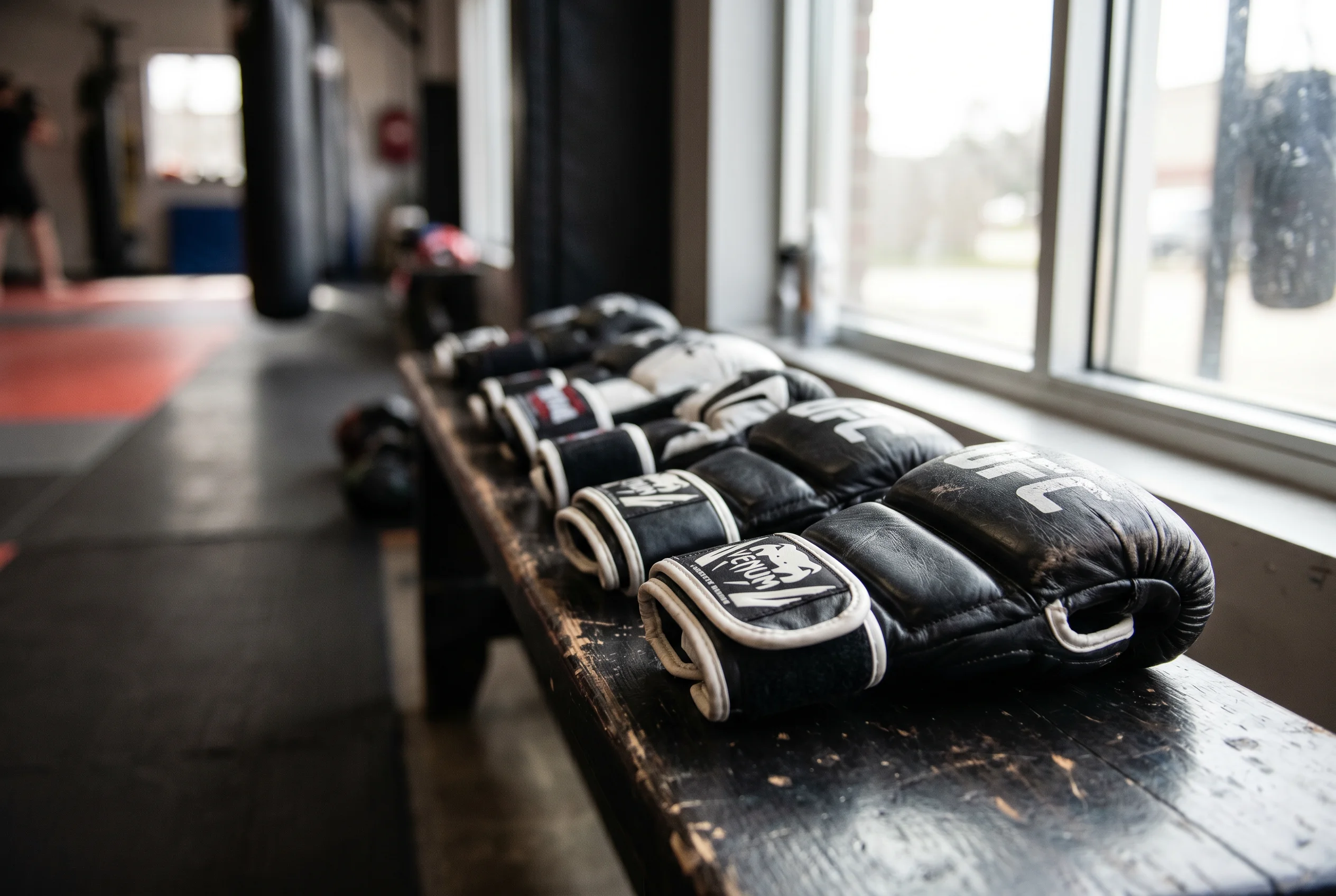 Row of UFC fight gloves lined up on a gym bench representing multiple accumulator selections
